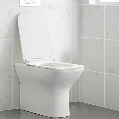 Square back-to-wall toilet bowl with flat lid and smooth sides in white ceramic.