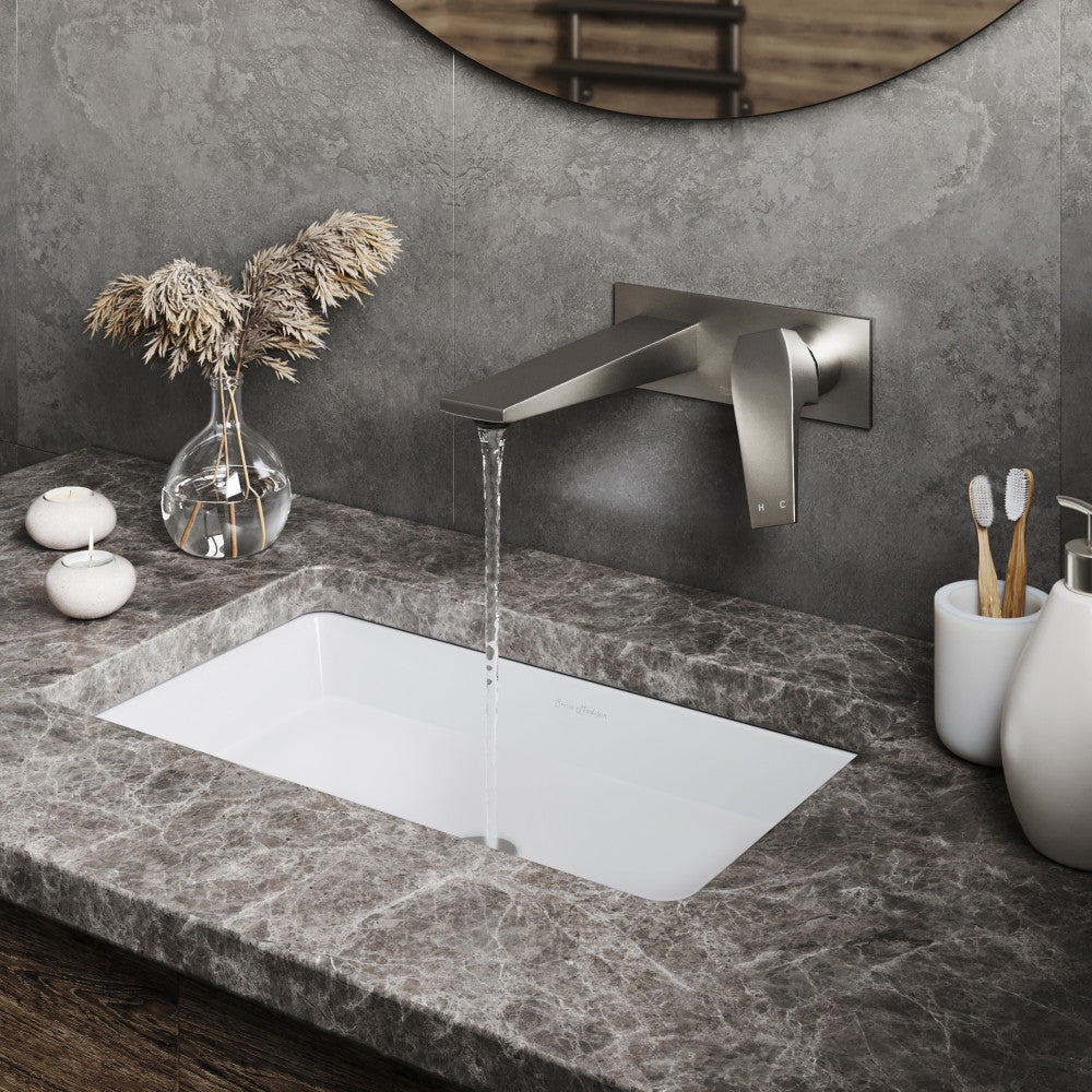 Wall-mount single-handle bathroom faucet in brushed nickel, sleek modern design with curved spout.
