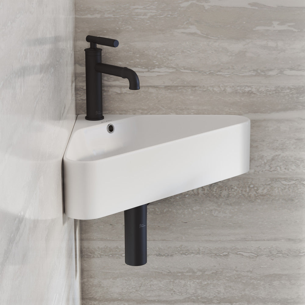 Corner wall-hung bathroom sink in white with black faucet and visible drainpipe.