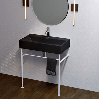 Matte black rectangular ceramic console sink with matte white metal legs and towel rail under basin.