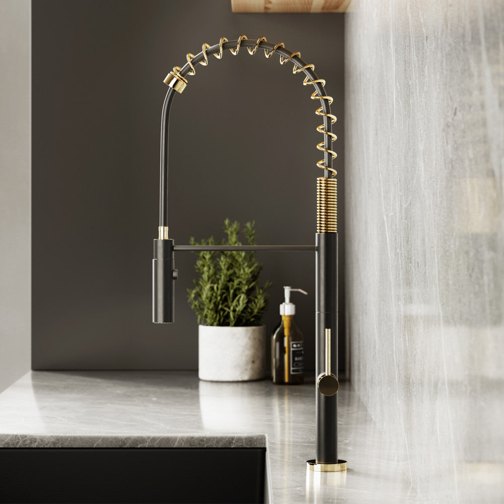 Single handle pull-down kitchen faucet in brushed gold and black with spring coil neck.