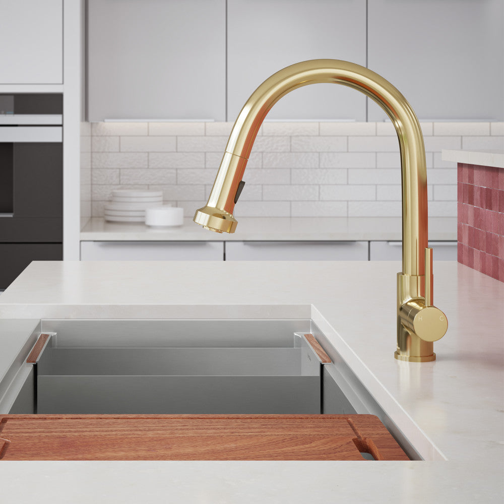 Single handle pull-down kitchen faucet in brushed gold finish, sleek curved spout.