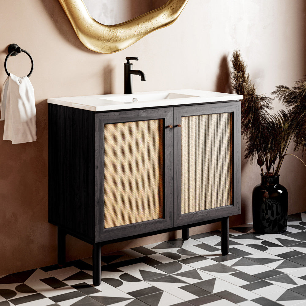36-inch freestanding bathroom vanity in black oak with white sink top and black single-handle faucet.